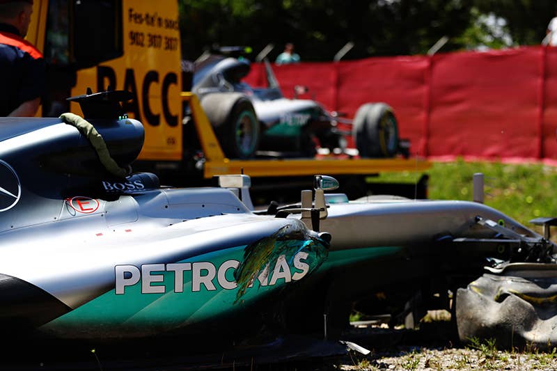 The broken cars of Lewis Hamilton of Great Britain and Mercedes GP and Nico Rosberg of Germany and Mercedes GP after they crashed into each other on the first lap during the Spanish Formula One Grand Prix