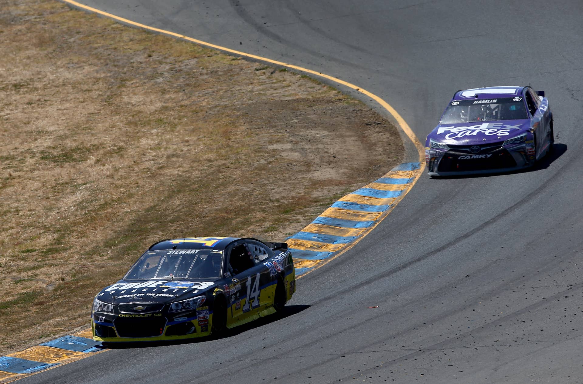 SONOMA, CA - JUNE 26: Tony Stewart, driver of the #14 Code 3 Assoc/Mobil 1 Chevrolet, leads Denny Hamlin, driver of the #11 FedEx Cares Toyota, during the NASCAR Sprint Cup Series Toyota/Save Mart 350 at Sonoma Raceway on June 26, 2016 in Sonoma, California. (Photo by Sarah Crabill/Getty Images)