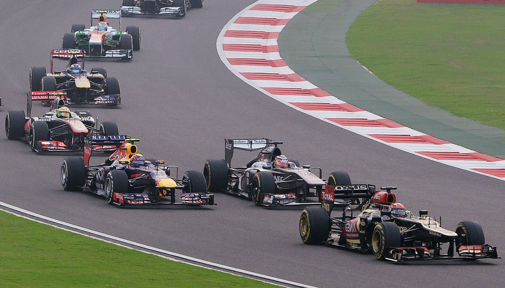 Lotus driver Kimi Raikkonen of Finland (R) leads the pack during the Formula One Indian Grand Prix in Greater Noida, on the outskirts of New Delhi on October 27, 2013.           AFP PHOTO/ Indranil MUKHERJEE        (Photo credit should read INDRANIL MUKHERJEE/AFP/Getty Images)