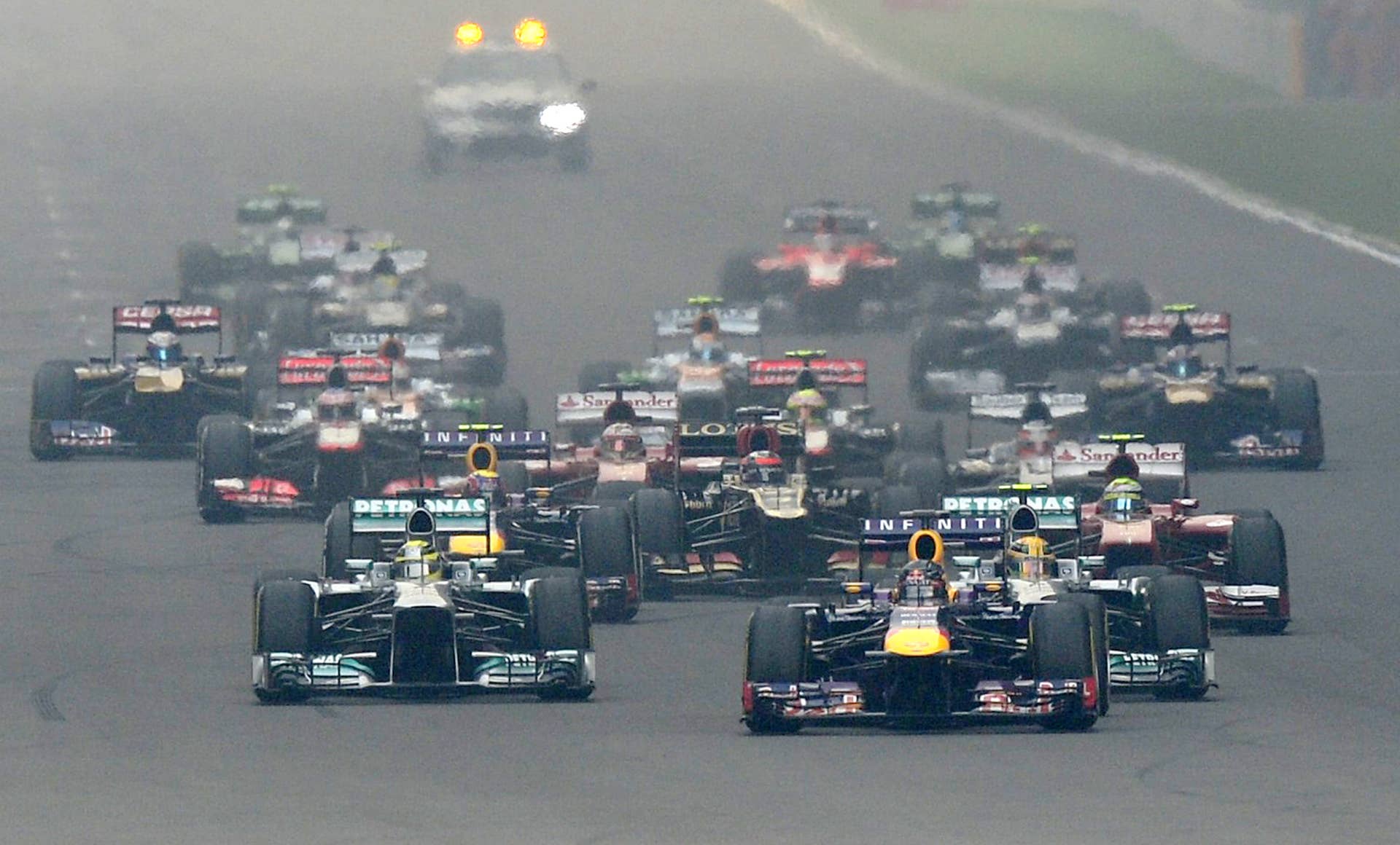 Red Bull driver Sebastian Vettel of Germany leads the pack at the start the Formula One Indian Grand Prix 2013 at the Buddh International circuit in Greater Noida, on the outskirts of New Delhi on October 27, 2013.  AFP PHOTO/MANAN VATSYAYANA        (Photo credit should read MANAN VATSYAYANA/AFP/Getty Images)