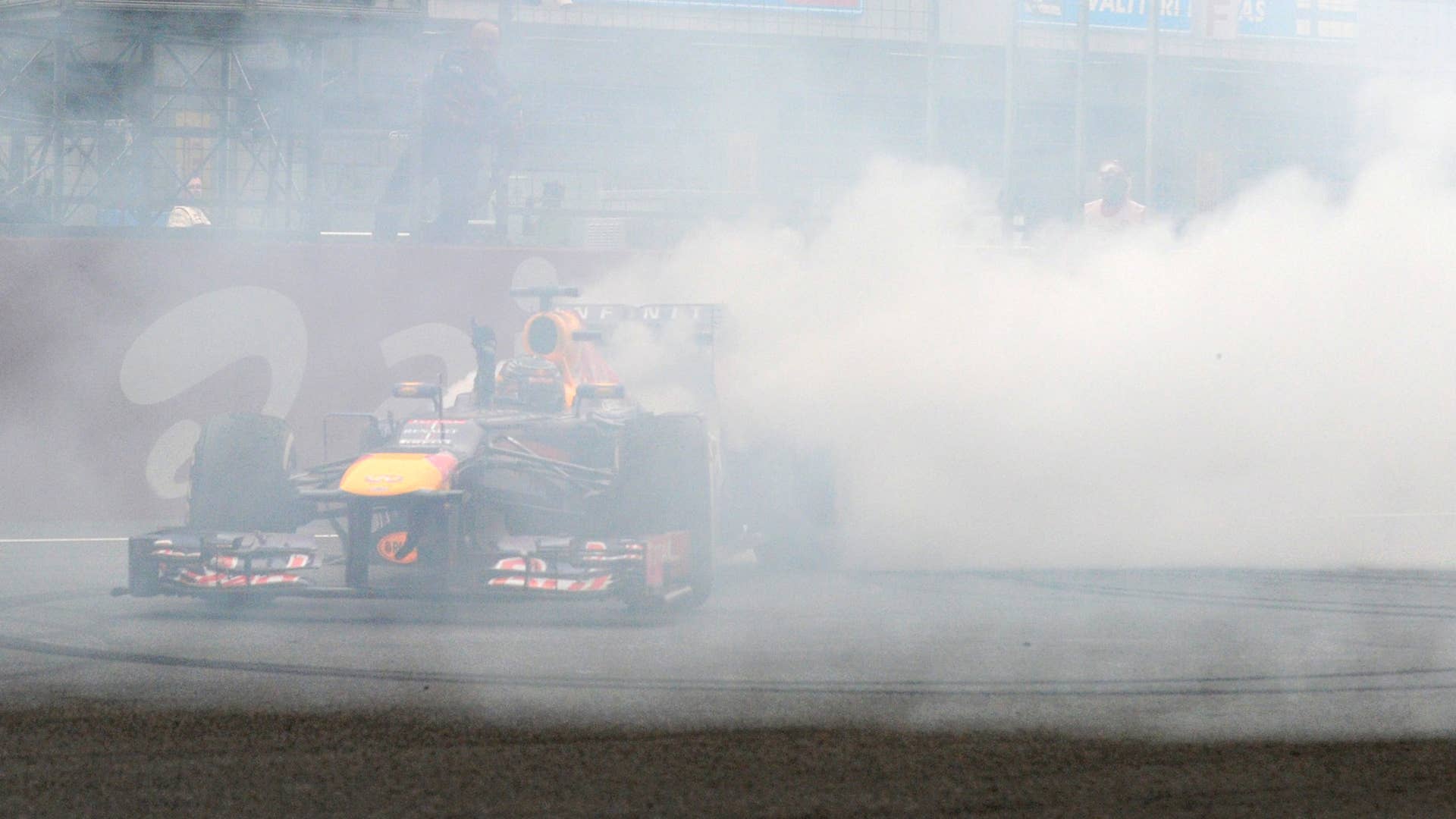 Red Bull driver Sebastian Vettel of Germany celebrates after winning the Formula One Indian Grand Prix and his fourth successive world title in Greater Noida, on the outskirts of New Delhi on October 27, 2013. AFP PHOTO/ Prakash SINGH        (Photo credit should read PRAKASH SINGH/AFP/Getty Images)