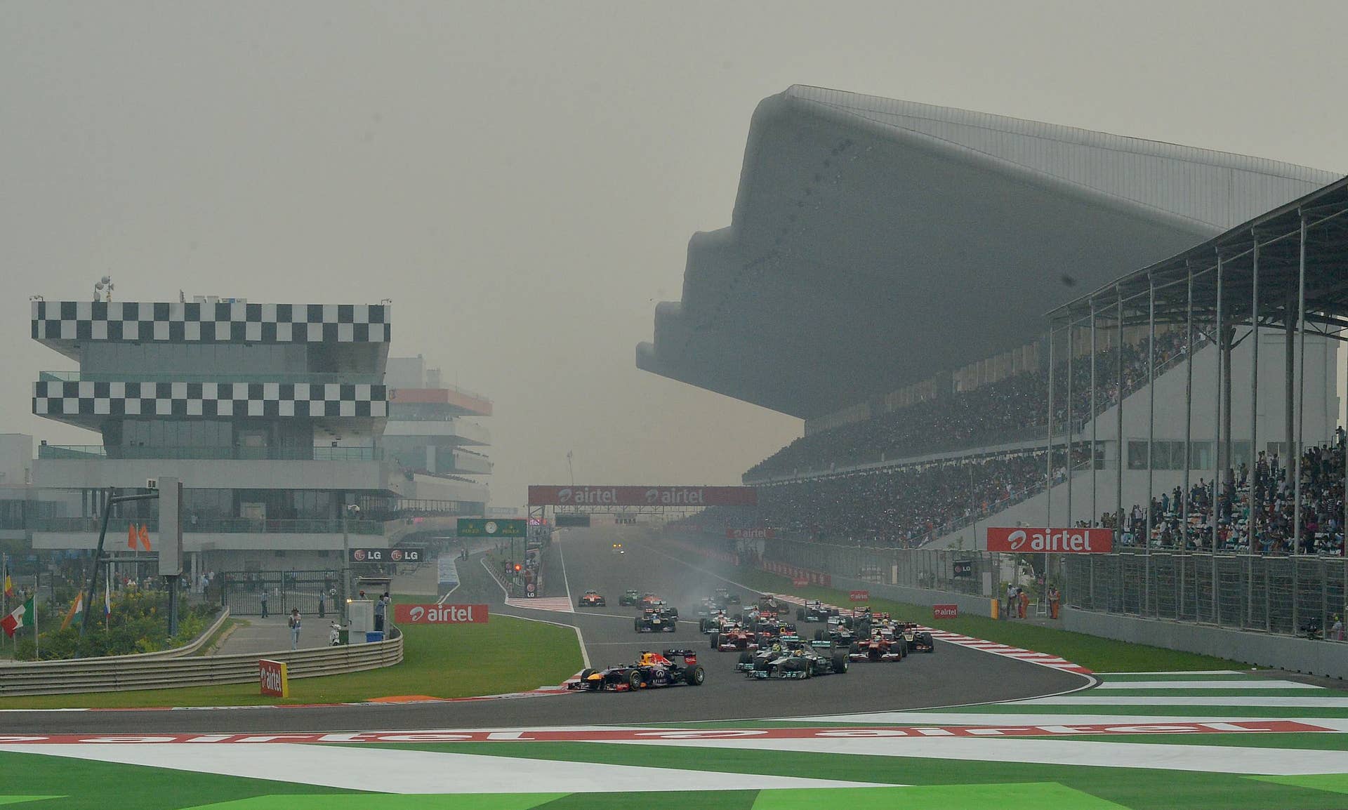 Red Bull driver Sebastian Vettel of Germany (L) leads the pack during the Formula One Indian Grand Prix 2013 at the Buddh International circuit in Greater Noida, on the outskirts of New Delhi on October 27, 2013.  AFP PHOTO/ MANAN VATSYAYANA        (Photo credit should read MANAN VATSYAYANA/AFP/Getty Images)