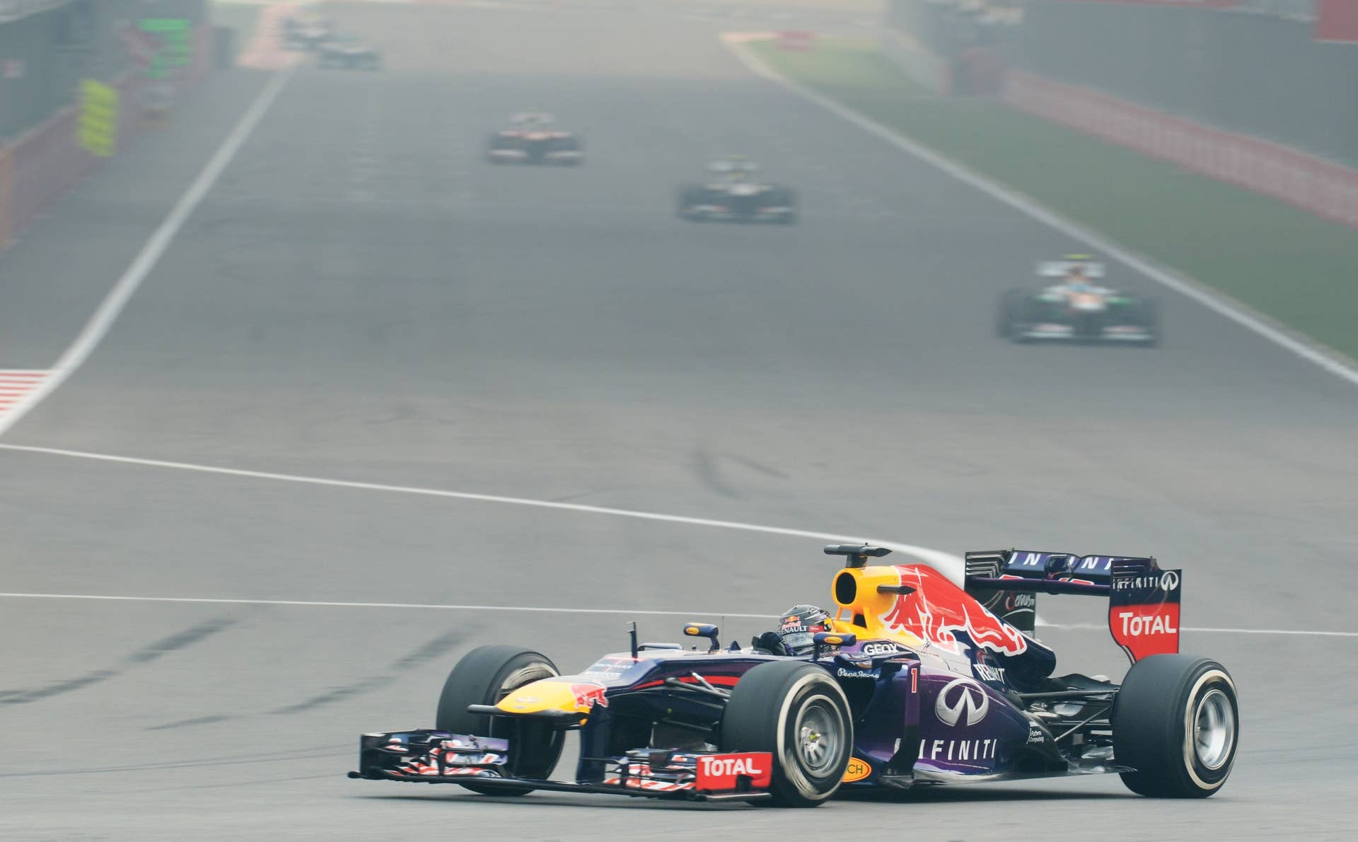 Red Bull team driver Sebastian Vettel of Germany drives his car at The Buddh International circuit in Greater Noida during the Formula One Indian Grand Prix on the outskirts of New Delhi on October 27, 2013.   AFP PHOTO/ROBERTO SCHMIDT        (Photo credit should read ROBERTO SCHMIDT/AFP/Getty Images)