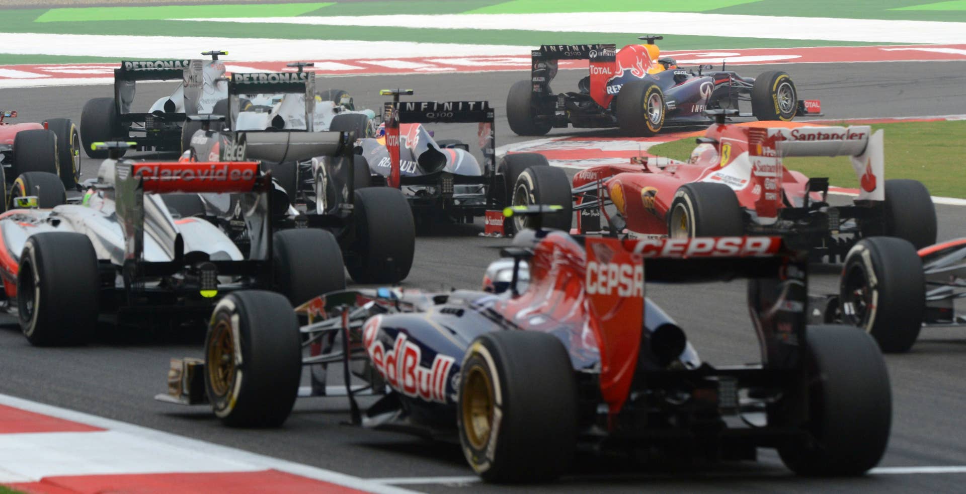 Red Bull driver Sebastian Vettel of Germany (top R) leads the pack during the Formula One Indian Grand Prix 2013 at the Buddh International circuit in Greater Noida, on the outskirts of New Delhi on October 27, 2013.      AFP PHOTO/ ROBERTO SCHMIDT        (Photo credit should read ROBERTO SCHMIDT/AFP/Getty Images)