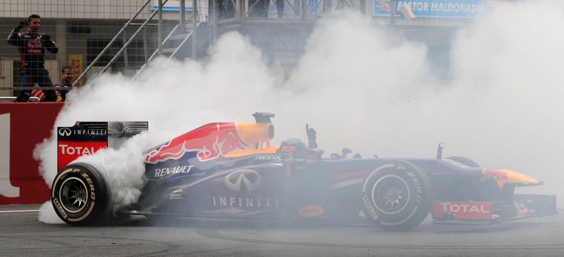 Red Bull driver Sebastian Vettel of Germany celebrates after winning the Formula One Indian Grand Prix 2013 at the Buddh International circuit in Greater Noida on the outskirts of New Delhi October 27,2013.AFP PHOTO/Prakash SINGH        (Photo credit should read PRAKASH SINGH/AFP/Getty Images)