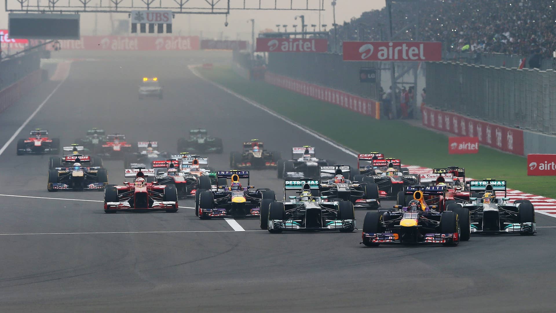 NOIDA, INDIA - OCTOBER 27:  Sebastian Vettel of Germany and Infiniti Red Bull Racing leads the field into the first corner at the start of the Indian Formula One Grand Prix at Buddh International Circuit on October 27, 2013 in Noida, India.  (Photo by Mark Thompson/Getty Images)
