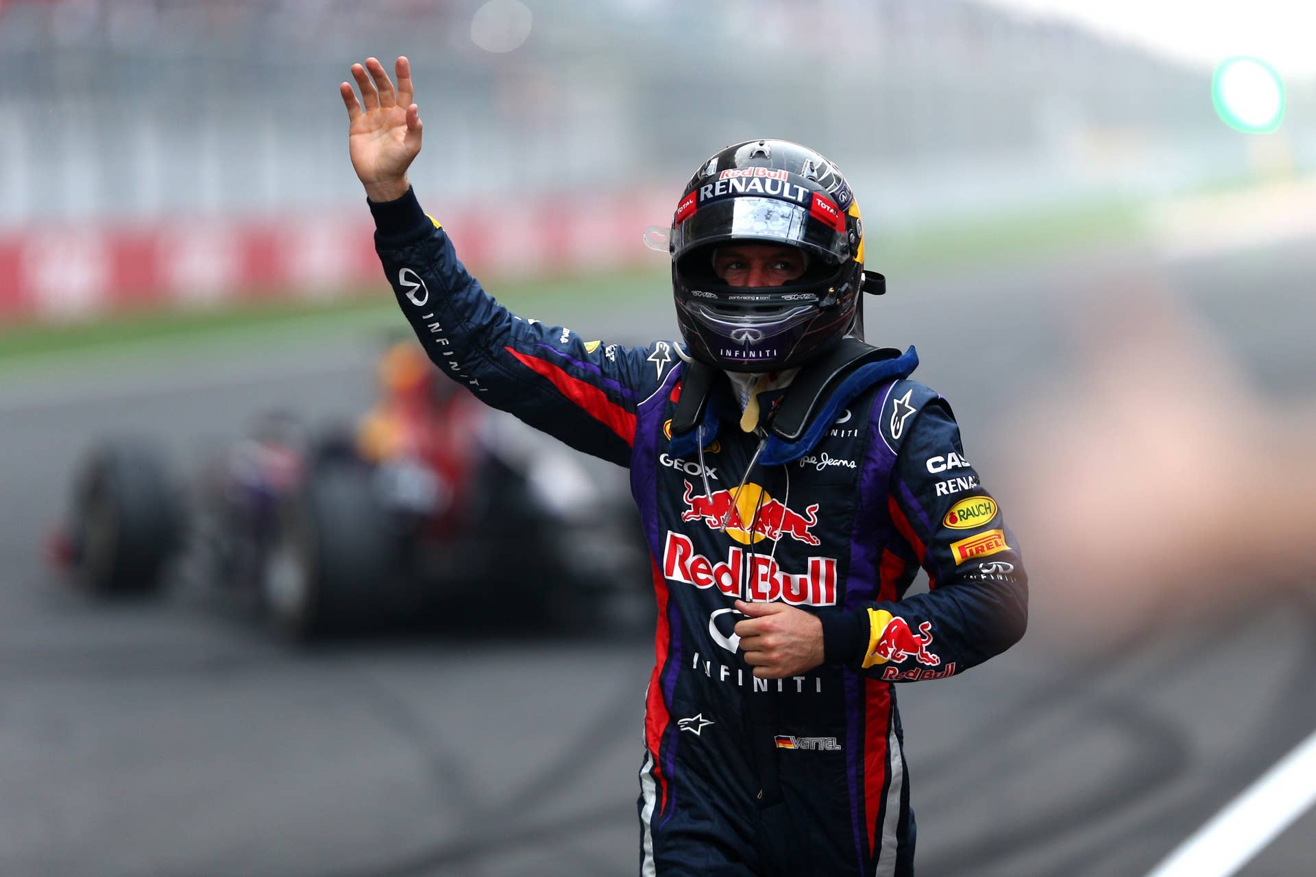 NOIDA, INDIA - OCTOBER 27:  Race winner and 2013 Formula One World Champion Sebastian Vettel of Germany and Infiniti Red Bull Racing celebrates in front of the crowd on the main straight following the Indian Formula One Grand Prix at Buddh International Circuit on October 27, 2013 in Noida, India.  (Photo by Paul Gilham/Getty Images)