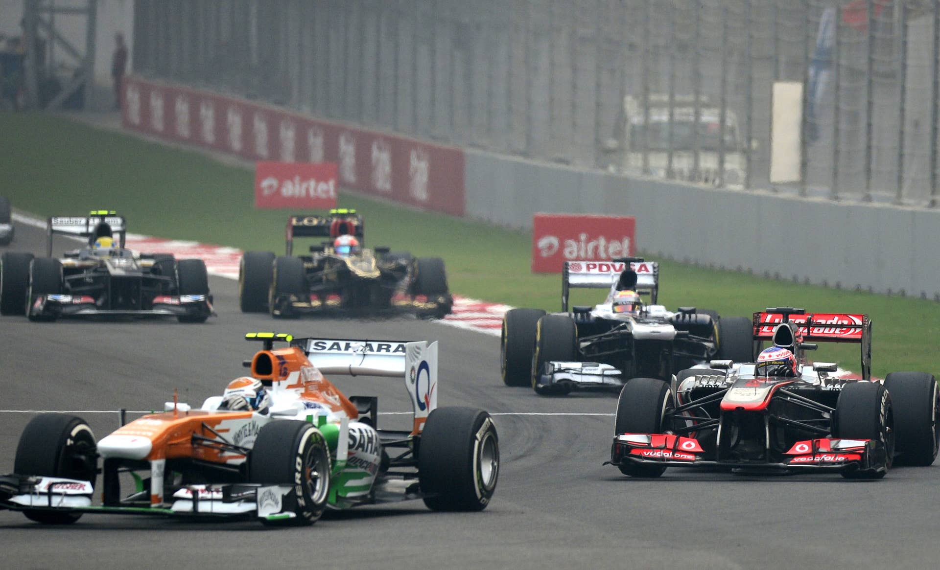 Force India driver Adrian Sutil of Germany (front) drives during the Formula One Indian Grand Prix 2013 at the Buddh International circuit in Greater Noida, on the outskirts of New Delhi on October 27, 2013. AFP PHOTO/MANAN VATSYAYANA        (Photo credit should read MANAN VATSYAYANA/AFP/Getty Images)