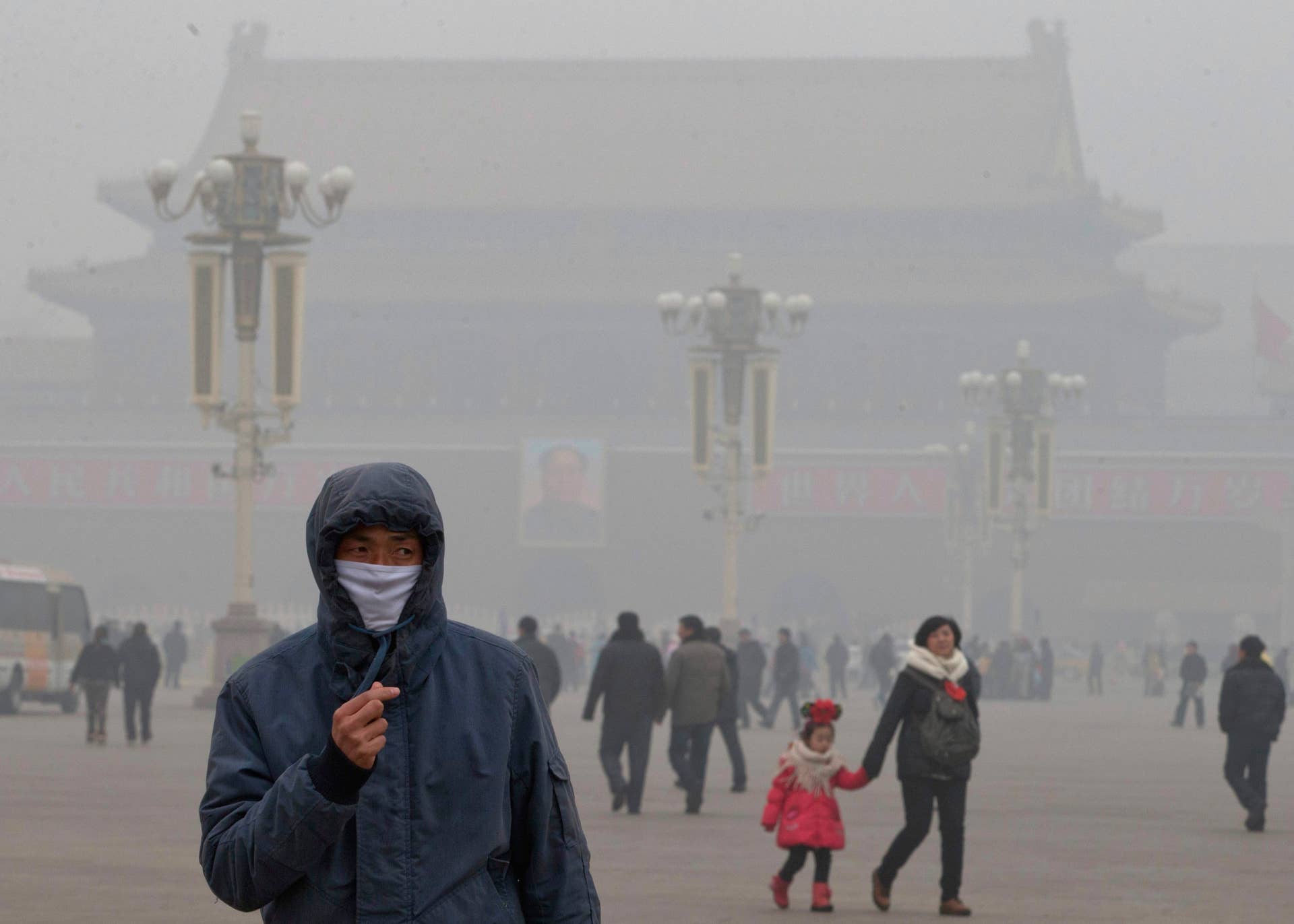FILE - In this Tuesday, Jan. 29, 2013 file photo, a man wears a mask on Tiananmen Square in thick haze in Beijing. Japan's Foreign Ministry says it is seeking to cooperate and exchange information with China on the recent bout of severe smog in many Chinese cities. (AP Photo/Ng Han Guan)