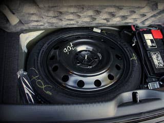 Over the past few years, several automakers have removed spare tires from the trunk. Some car companies today are making the spare tire an option– costing as much as $350.  While some drivers might be shocked to open their trunk and find no spare tire hiding anywhere in the back, the industry says it isn't unsafe to go without. Mandatory tire pressure monitoring systems, which are on all cars since 2006, should alert drivers before their tires deflate. Blowouts are rare. And even if the tire is punctured on the side wall, most drivers have cellphones to call AAA, or access to emergency services like OnStar, through their car.  Photo Credit: HighTechDad, Flickr