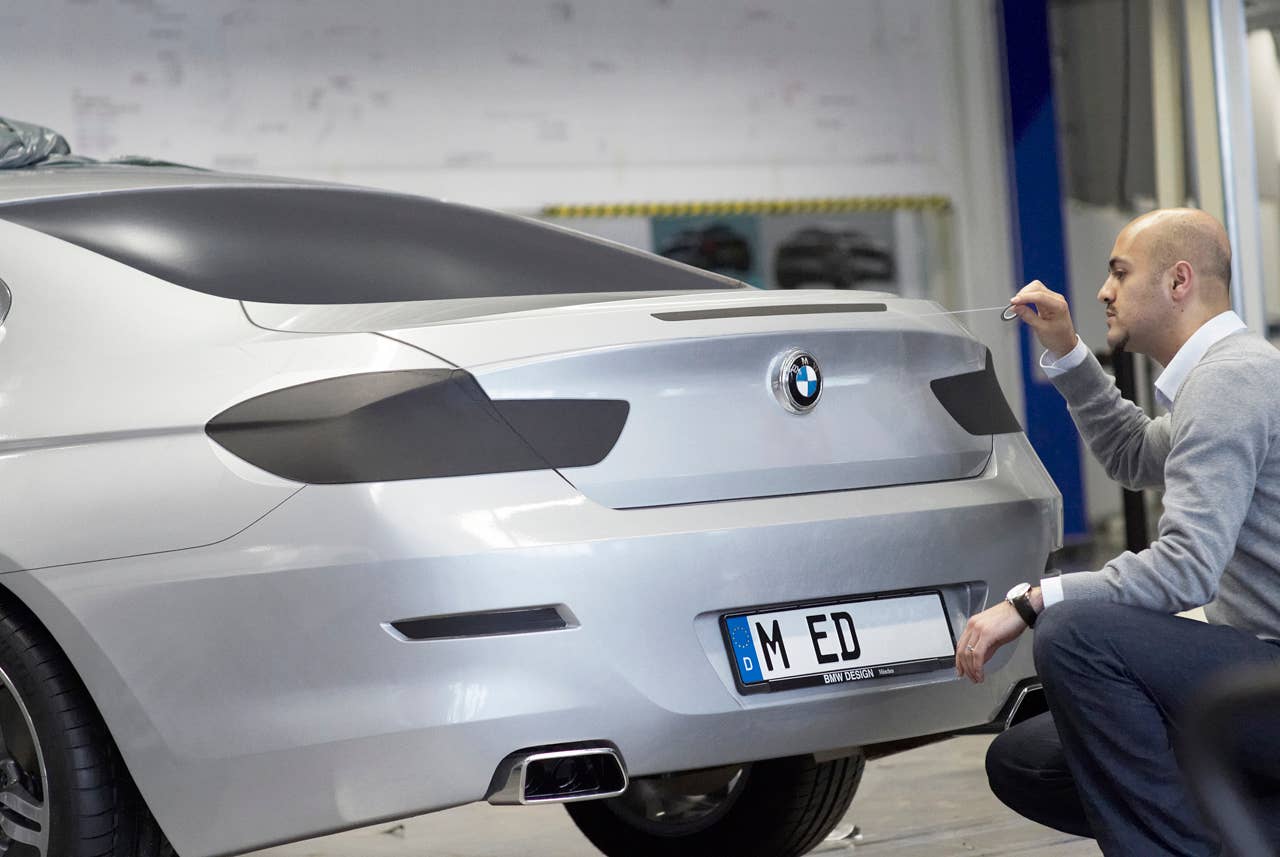 Nader Faghizadeh (Exterior Designer BMW 6 Series Coupe) taping a foiled clay model of the BMW 6  Series Coupe (03/2011),