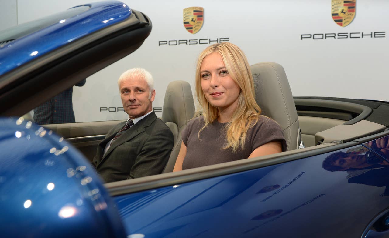 Russian tennis player Maria Sharapova and CEO of German car manufacturer Porsche Matthias Mueller pose for photographers inside a Porsche 911 in Stuttgart,southern Germany, on April 22, 2013. Sharapova will be the first global ambassador for German car manufacturer Porsche.  AFP PHOTO / FRANZISKA KRAUFMANN   GERMANY OUTFRANZISKA KRAUFMANN/AFP/Getty Images