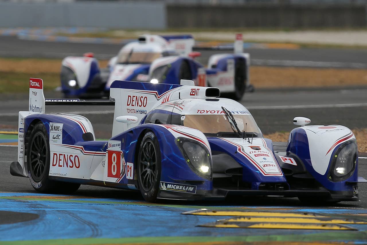 The Toyota TS030 Hybrid n8 driven by Antony Davidson of Britain, Sebastien Buemi of Switzerland and Stephane Sarrazin of France is seen in action ahead of the Toyota n7 during the qualifying practice session of the 80th 24-hour Le Mans endurance race, in Le Mans, western France, Thursday, June 14, 2012. The race will begin on Saturday, June 16. (AP Photo/David Vincent)