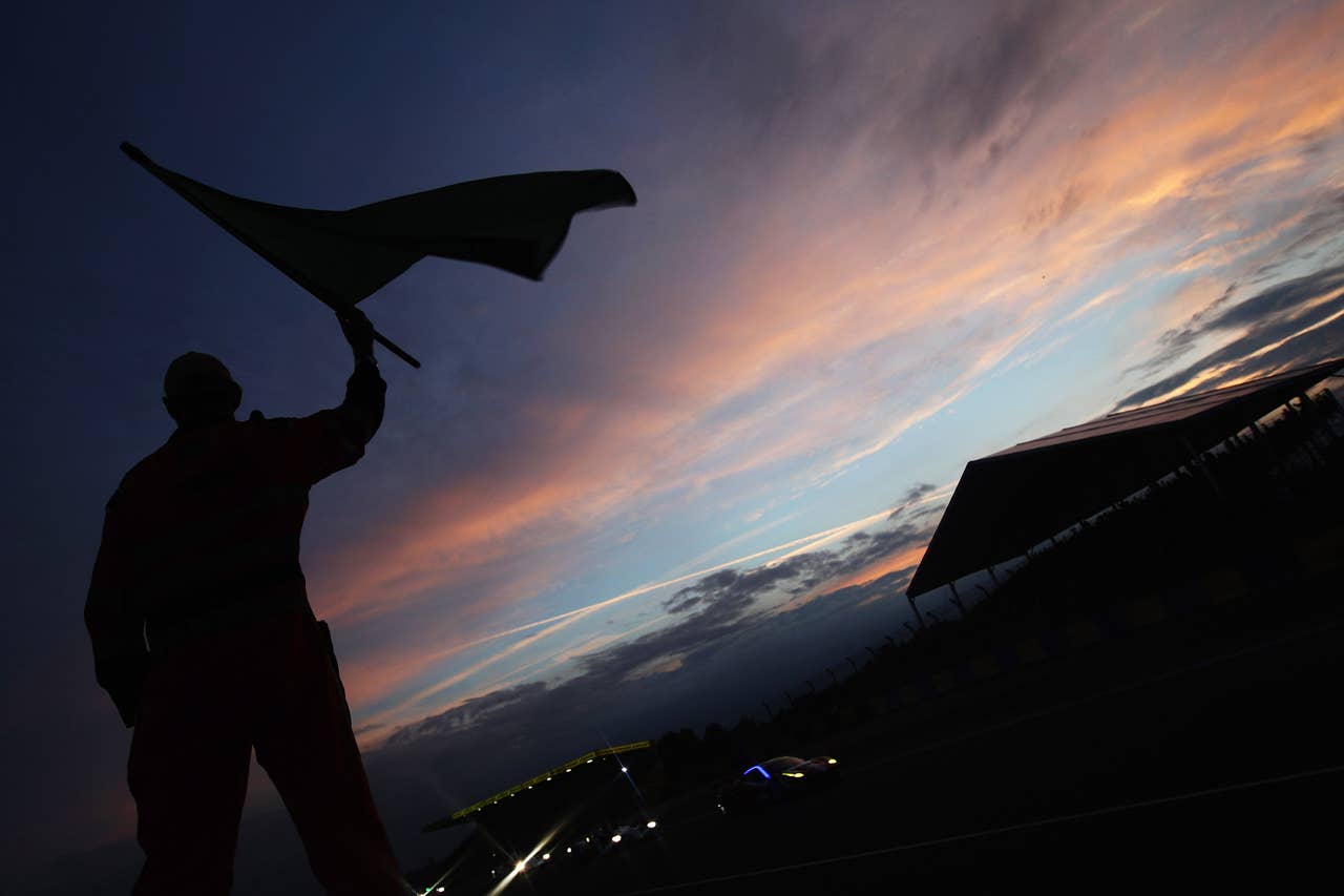 LE MANS, FRANCE - JUNE 14: Race marshall waves the green flag at the start of qualifying for the Le Mans 24 Hour race at the Circuit de la Sarthe on June 14, 2012 in Le Mans, France. (Photo by Ker Robertson/Getty Images) *** BESTPIX ***