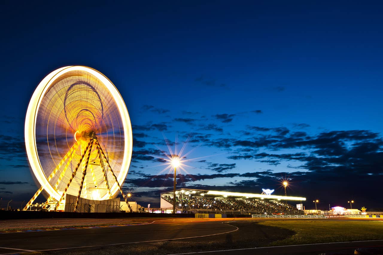 LE MANS, FRANCE - JUNE 13:  The ferris wheel and spectator grandstand during practice for the 80th running of the Le Mans 24 Hour race at the Circuit des 24 Heures du Mans on June 13, 2012 in Le Mans, France  (Photo by Drew Gibson/Getty Images)