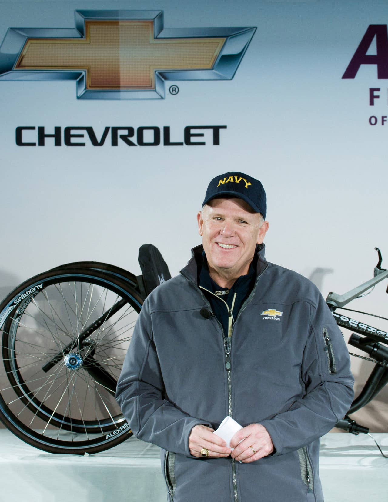 General Motors Chairman and CEO Dan Akerson address the gathering at a press conference unveiling a new prototype hand cycle designed to make it easier for wounded veterans to compete in racing events Saturday, December 8, 2012 prior to the Army-Navy football game in Philadelphia, PA. GM will fund the building of 10 prototype hand cycles for use in marathons next year. (Photo by Janette McVey for Chevrolet)