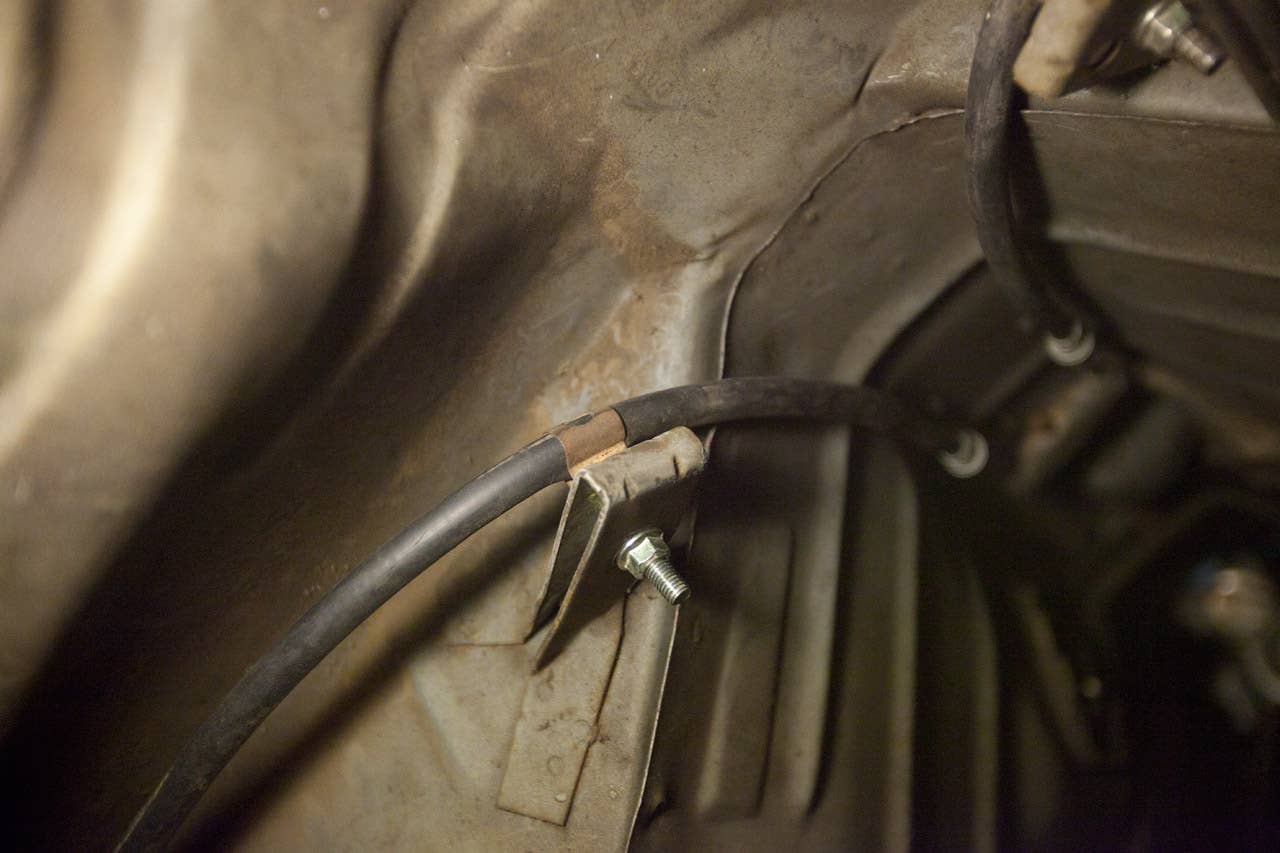 Independent rear suspension emergency brake cables in place