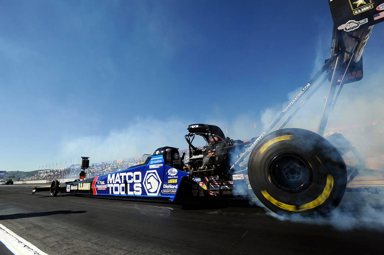 In this photo provided by NHRA, Top Fuel world champion Antron Brown performs a burnout during eliminations at the Auto Club NHRA auto race finals on Sunday, Nov. 11, 2012, in Pomona, Calif. (AP Photo/NHRA, Marc Gewertz)