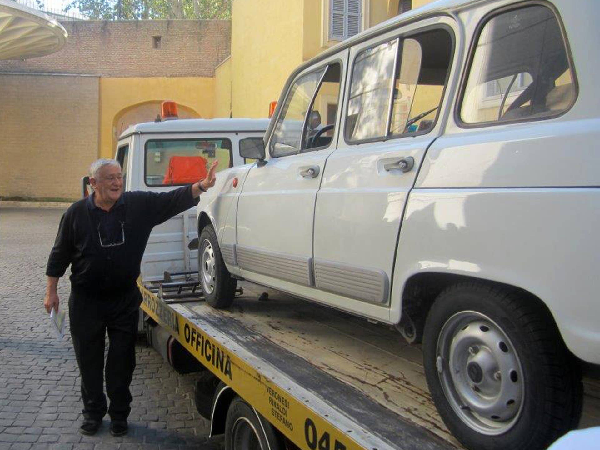 In this picture taken with a smartphone on Saturday, Sept. 7, 2013 and provided by NGO Fondazione L'Ancora ONLUS, Rev. Renzo Zocca, parish priest of Santa Lucia di Pescantina, in Verona, northern Italy, pats his Renault 4L as it is brought inside the Vatican to be donated to Pope Francis. Rev. Zocca, 70, told the Associated Press on Wednesday, Sept. 11, 2013, that he has dedicated his life to helping the needy on the outskirts of Verona, so when he saw that Pope Francis' priority was to reach out to the world's poor and inspire the Catholic leaders to go to slums and peripheries to preach, he decided to donate what he calls his 25-year-old "car of the French farmers" as a symbol of this approach. The pontiff invited Rev. Zocca for a private audience and on that occasion the priest had the car brought to the Vatican. (AP Photo/Fondazione L'Ancora ONLUS, ho)