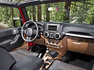 Here is where the die-hard off-roading Jeep enthusiasts and I might part ways. The interior of the Sahara we tested was delightful. It came with soft brown leather seats, which made it feel as if you were a cowboy riding in a really comfy saddle. It came with all the creature comforts– navigation, a USB port inside a lockable arm rest so you can stow away your iPhone but still listen to music, heated seats, tire pressure monitoring, power windows, a leather wrapped steering wheel and a temperature and compass gauge.  Not exactly roughing it, I admit. But I am not someone who thinks you need to suffer in a bare bones off roader in order to feel like you've accomplished something. A little butt warmer on a cold day out in the forest could actually come in quite handy. A lot of off-roading enthusiasts would disagree.