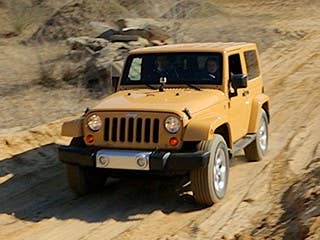 This is the one of the Jeepiest Jeeps on the market. Everything about its exterior shows this truck is made with purpose in mind.  The exterior hinges on the door show how easily the doors can be removed– which is useful when off roading so the driver can see rocks and other obstacles on the side of the car. The latches to the hood are on the outside. It comes with giant wheels – the size depends on which model you are driving, but the Sahara we tested came with 18-inch wheels with on- and off-road tires.  There is nothing trendy about this truck. Current fashion inSUVs is to make them smaller and more car-like, but the Jeep Wrangler is all truck. It looks similar to the first Wrangler, born in 1986. They have a similar grill, similar boxy stance, and same fenders that don't quite reach the bumper. But the 1986 version came with optional square headlights, and the modern truck comes with just circular headlights.  If you loved the Wrangler at any point in its 27-year existence, there's no reason you won't love the looks of the current model.