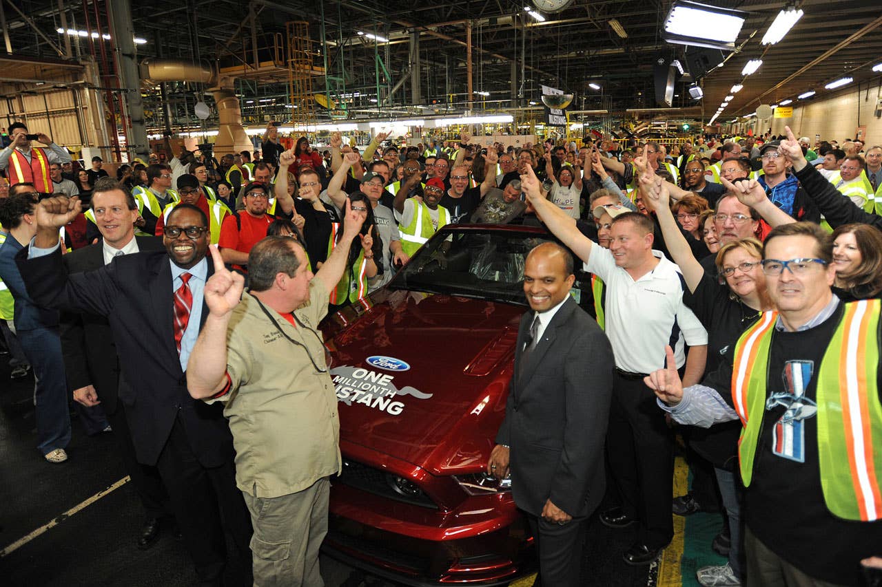 Flat Rock, Mi. Tim Young, Flat Rock Assembly Plant, plant manager, Raj Nair, group vice president for product development, Dave Pericak, chief Mustang engineer, Tony Bondy, UAW Local 3000 chairman, Jimmy Settles, UAW vice president, pose in front of the 1 millionth commemorative Mustang at the Flat Rock Assembly Plant. (04/17/2013)