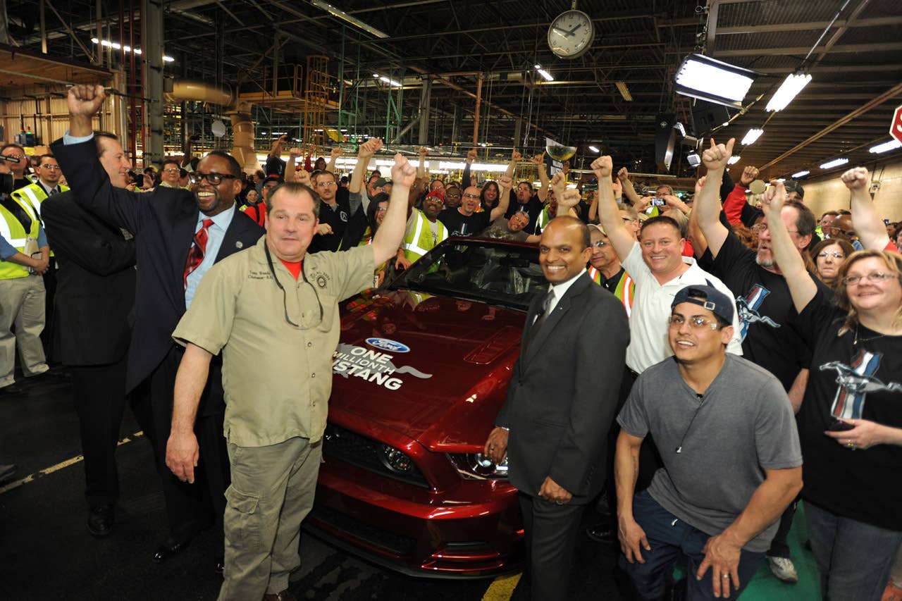 Flat Rock, Mi. Tim Young, Flat Rock Assembly Plant, plant manager, Raj Nair, group vice president for product development, Dave Pericak, chief Mustang engineer, Tony Bondy, UAW Local 3000 chairman, Jimmy Settles, UAW vice president, pose in front of the 1 millionth commemorative Mustang at the Flat Rock Assembly Plant. (04/17/2013)