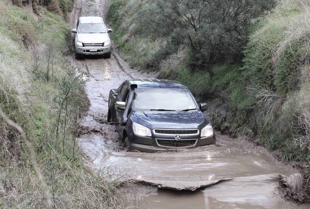 Holden Colorado plunges into deep mud ahead of the Ford Ranger