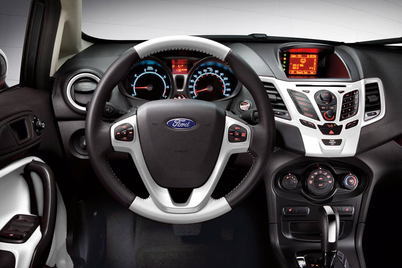 Ford Fiesta launches three new personalization packages for 2012, including two interior packages and one exterior package offering customers the ultimate in customization.  Shown here is the new interior package which delivers a custom look with two-tone seating surfaces, door trim inserts, steering wheel and interior components, available in both Race Red and Oxford White. (03/23/2011)