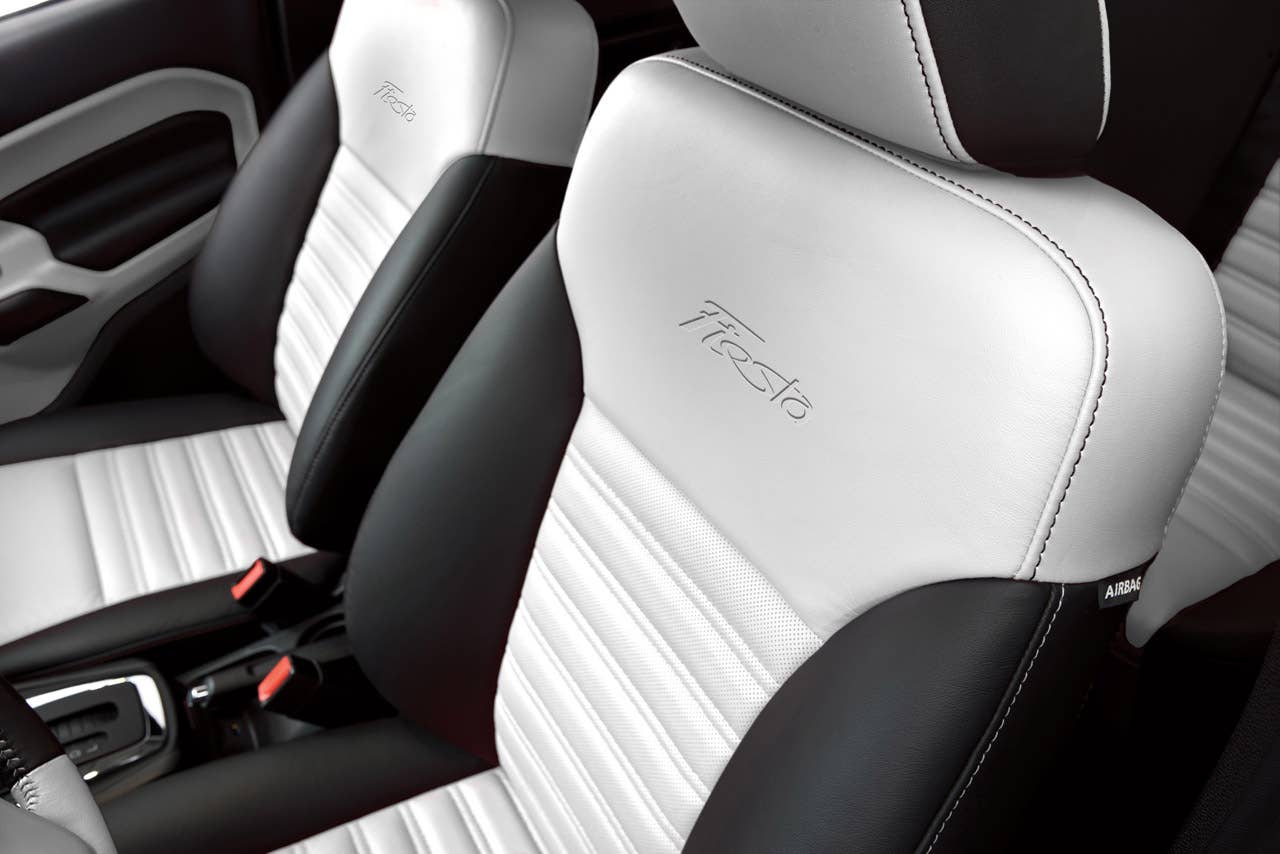 Ford Fiesta launches three new personalization packages for 2012, including two interior packages and one exterior package offering customers the ultimate in customization.  Shown here is the new interior package which delivers a custom look with two-tone seating surfaces, door trim inserts, steering wheel and interior components, available in both Race Red and Oxford White. (03/23/2011)