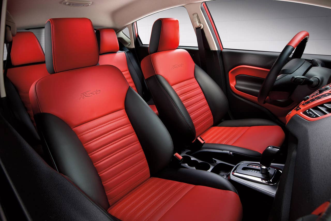Ford Fiesta launches three new personalization packages for 2012, including two interior packages and one exterior package offering customers the ultimate in customization.  Shown here is the new interior package which delivers a custom look with two-tone seating surfaces, door trim inserts, steering wheel and interior components, available in both Race Red and Oxford White. (03/23/2011)