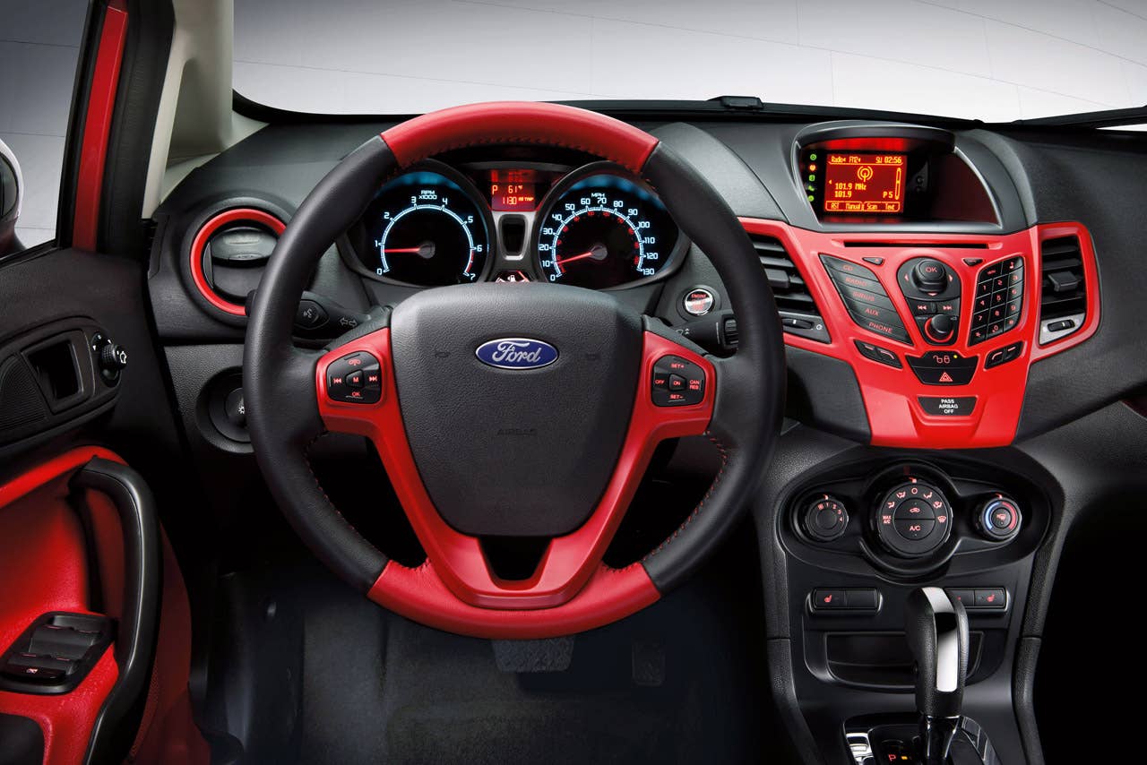 Ford Fiesta launches three new personalization packages for 2012, including two interior packages and one exterior package offering customers the ultimate in customization. Shown here is the new interior package which delivers a custom look with two-tone seating surfaces, door trim inserts, steering wheel and interior components, available in both Race Red and Oxford White. (03/23/2011)