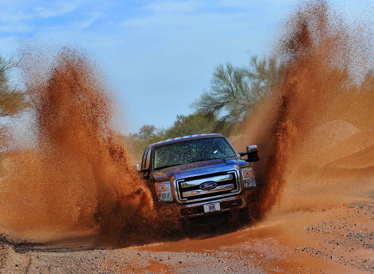 PHOENIX, AZ., March 2, 2010-- The 2011 Ford F-Series Super Duty splashes through water on an unimproved road. The 2011 Ford F-Series Super Duty has new available off-road features, including electronic locking rear differential, new Hill Descent Control and all-new transfer case skid plate. Photo by: Sam VarnHagen/Ford Motor Co. (3/8/2010)