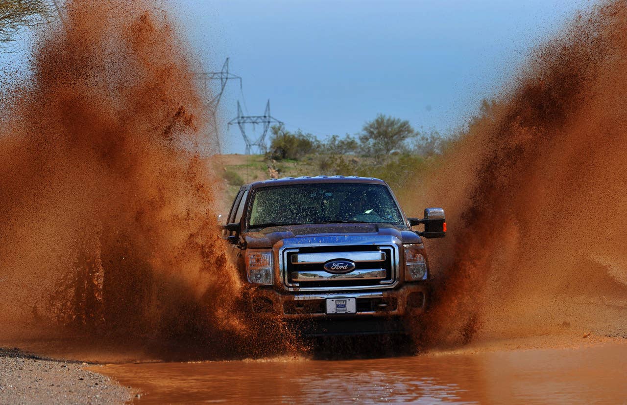 PHOENIX, AZ., March 2, 2010-- The 2011 Ford F-Series Super Duty splashes through water on an unimproved road. The 2011 Ford F-Series Super Duty has new available off-road features, including electronic locking rear differential, new Hill Descent Control and all-new transfer case skid plate.  Photo by: Sam VarnHagen/Ford Motor Co. (3/8/2010)