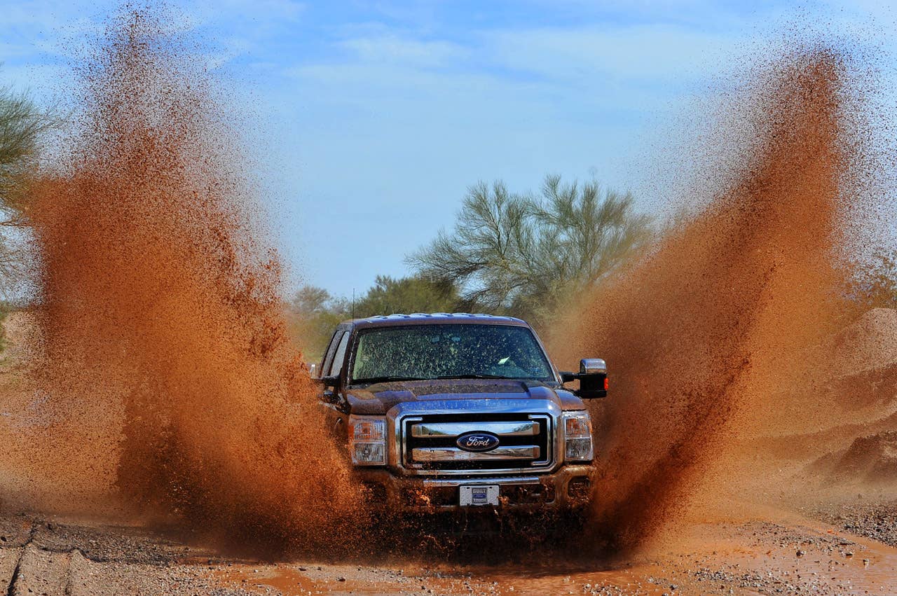PHOENIX, AZ., March 2, 2010--  The 2011 Ford F-Series Super Duty splashes through water on an unimproved road. The 2011 Ford F-Series Super Duty has new available off-road features, including electronic locking rear differential, new Hill Descent Control and all-new transfer case skid plate.  Photo by: Sam VarnHagen/Ford Motor Co. (3/8/2010)