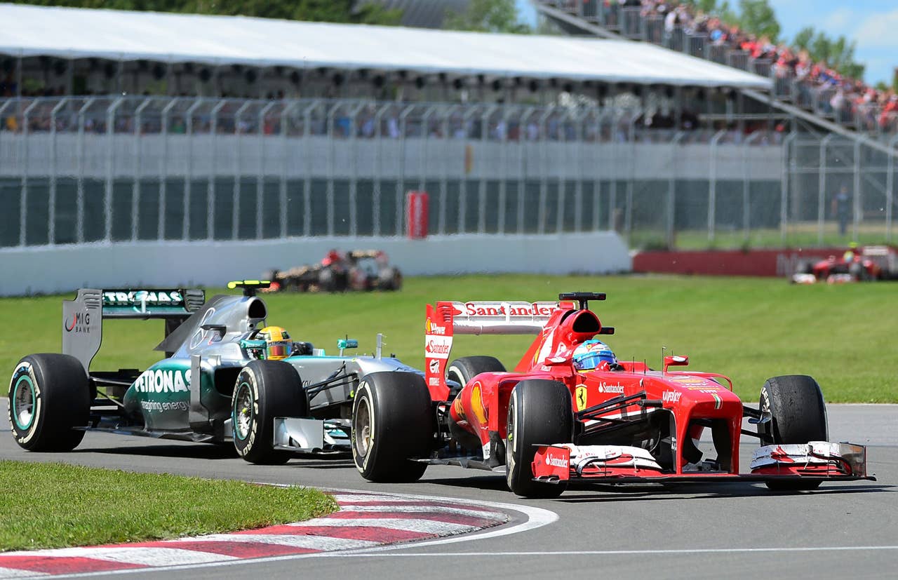 Ferrari driver Fernando Alsonso of Spain powers his car ahead of Mercedes driver Lewis Hamilton of Britain in the Canadian Formula One Grand Prix at the Circuit Gilles Villeneuve in Montreal, June 9, 2013. Alonso placed second and Hamilton third behind Red Bull driver Sebastian Vettel of Germany.    AFP PHOTO/Emmanuel DunandEMMANUEL DUNAND/AFP/Getty Images
