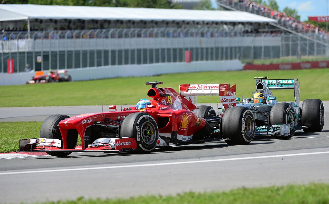 Ferrari driver Fernando Alsonso of Spain powers his car ahead of Mercedes driver Lewis Hamilton of Britain in the Canadian Formula One Grand Prix at the Circuit Gilles Villeneuve in Montreal, June 9, 2013. Alonso placed second and Hamilton third behind Red Bull driver Sebastian Vettel of Germany.    AFP PHOTO/Emmanuel DunandEMMANUEL DUNAND/AFP/Getty Images