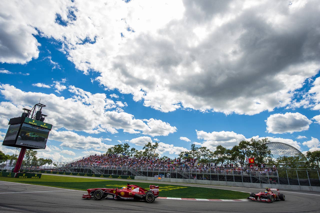 Scuderia Ferrari Fernando Alonso of Spain and Felipe Massa of Brazil at the hairpin corner, during the F1 Grand Prix race at the Circuit Gilles Villeneuve in Montreal on June 9, 2013 during the Canadian Formula One Grand Prix.   AFP PHOTO / ROGERIO BARBOSAROGERIO BARBOSA/AFP/Getty Images