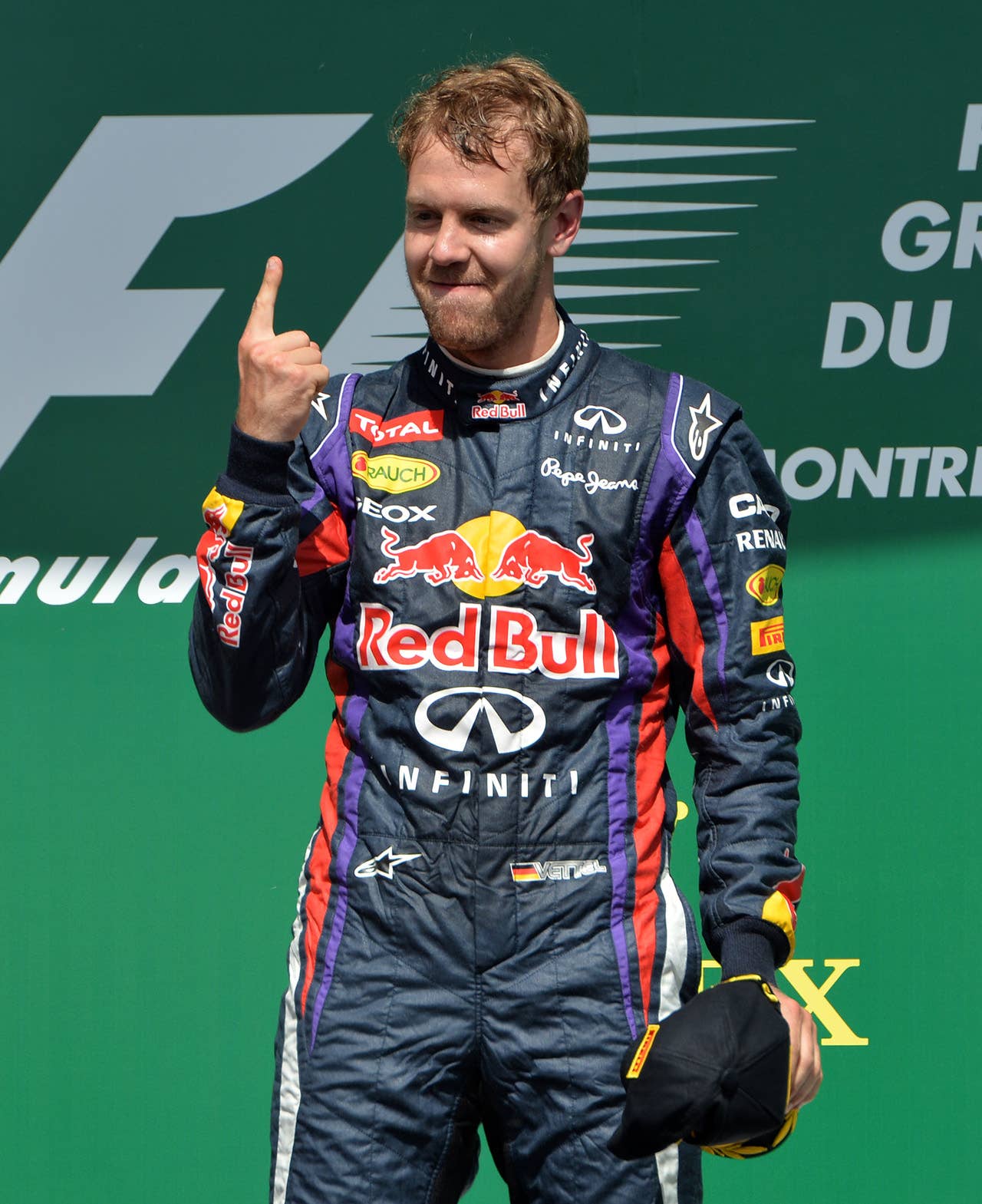 (CORRECTION-IPTC-BYLINE) Red Bull driver Sebastian Vettel of Germany celebrates on the podium after winning the Canadian Formula One Grand Prix at the Circuit Gilles Villeneuve in Montreal on June 9, 2013.    AFP PHOTO/Stan HONDASTAN HONDA/AFP/Getty Images
