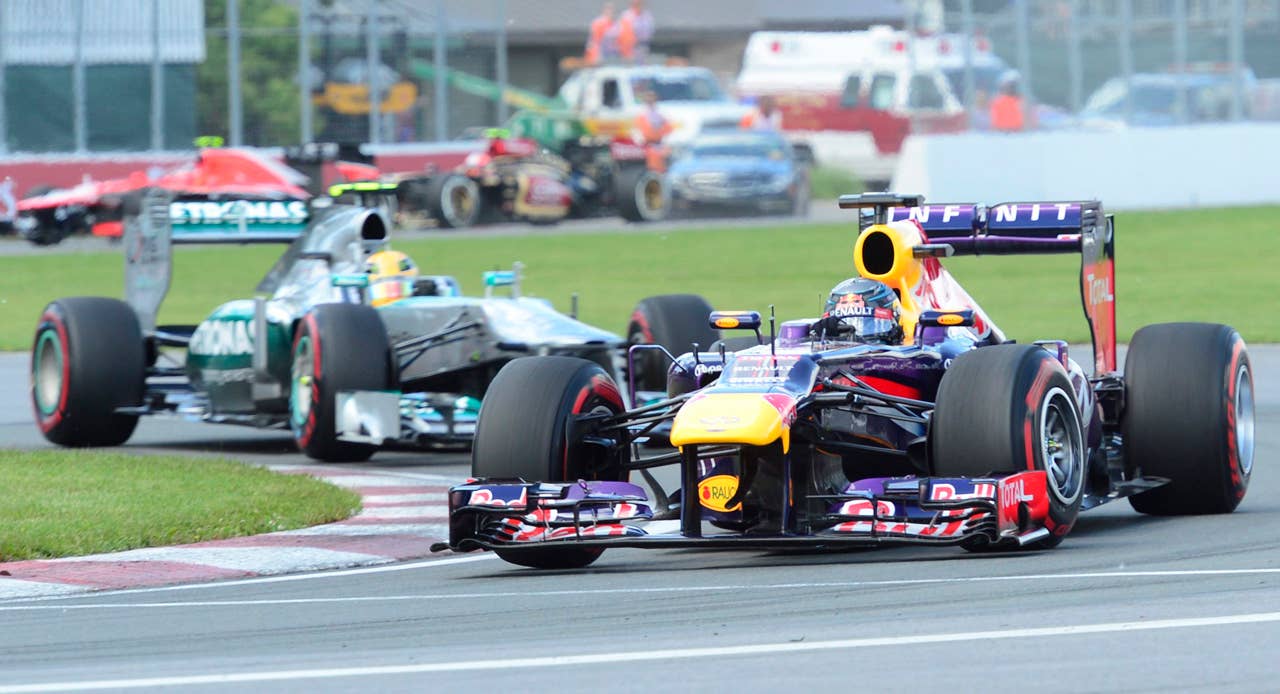 Red Bull driver Sebastian Vettel, right, of Germany, leads Mercedes driver Lewis Hamilton, of Britain, during the Canadian Grand Prix auto race in Montreal, Sunday, June 9, 2013. (AP Photo/The Canadian Press, Paul Chiasson)