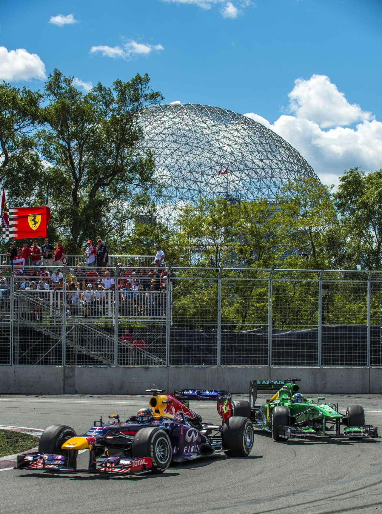 Red Bull driver Sebastian Vettel of Germany leads the race as he overtakes Catherham's Charles Pic of France at the hairpin corner at the Circuit Gilles Villeneuve in Montreal on June 9, 2013 during the Canadian Formula One Grand Prix.   AFP PHOTO / ROGERIO BARBOSAROGERIO BARBOSA/AFP/Getty Images