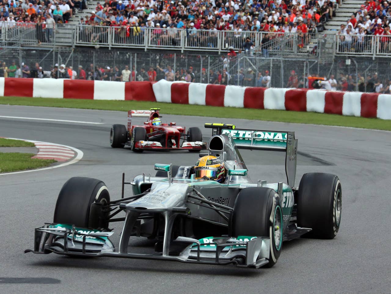 Mercedes driver Lewis Hamilton of Britain leads Ferrari driver Felipe Massa of Brazil through the Senna corner at the Canadian Grand Prix, Sunday, June 9, 2013 in Montreal. (AP Photo/The Canadian Press, Tom Boland)