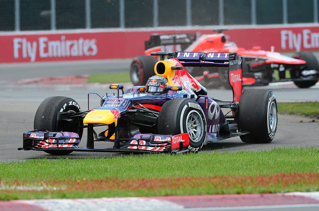 Red Bull driver Sebastian Vettel of Germany misses a turn and goes off track on his way to win the Canadian Formula One Grand Prix at the Circuit Gilles Villeneuve in Montreal on June 9, 2013.    AFP PHOTO/Emmanuel DunandEMMANUEL DUNAND/AFP/Getty Images