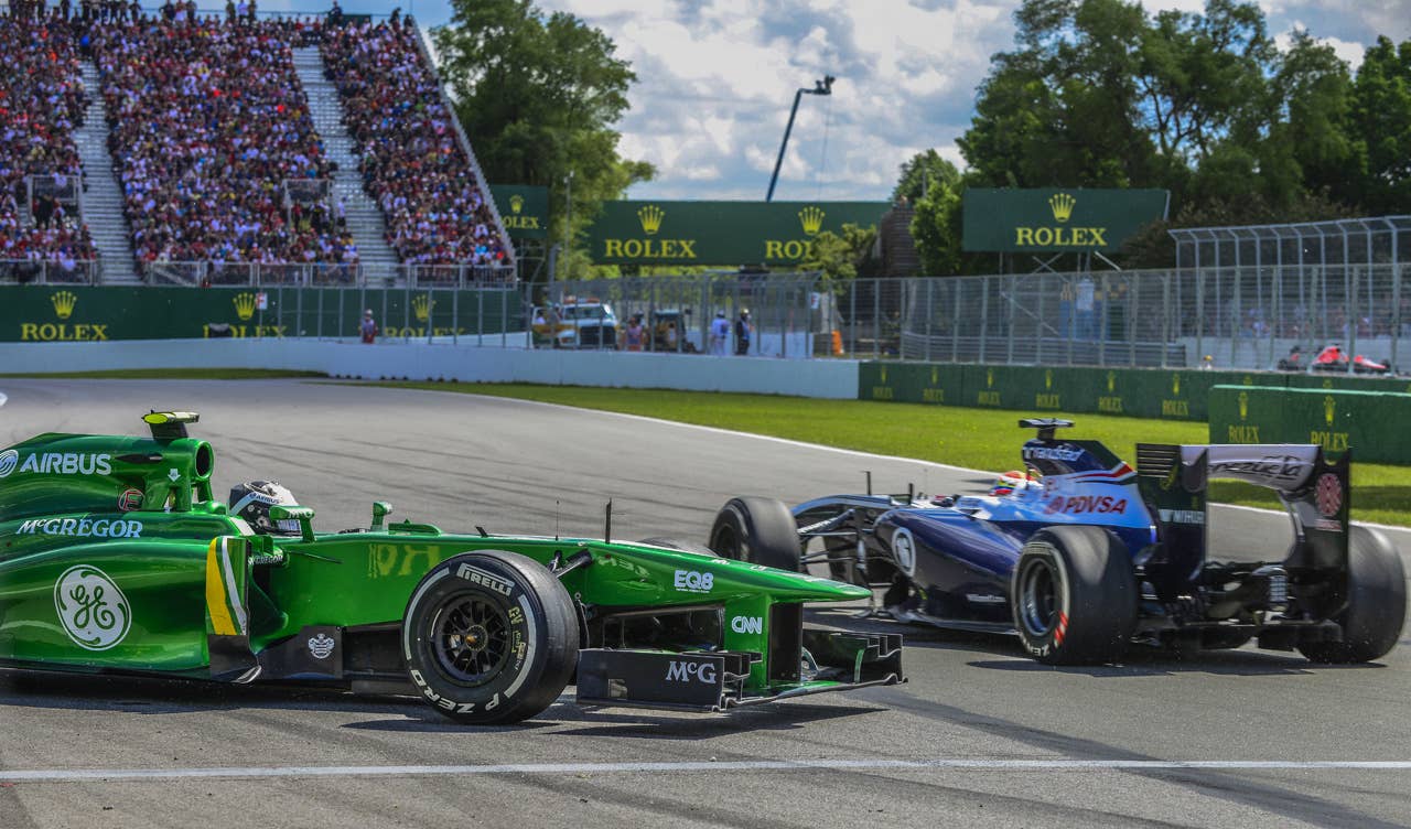 Catherham driver Giedo Van Der Garde of the Netherlands stands on the side of the track after being hit by Red Bull driver Mark Webber from Australia at the hairpin corner at the Circuit Gilles Villeneuve in Montreal on June 9, 2013 during the Canadian Formula One Grand Prix.    AFP PHOTO / ROGERIO BARBOSAROGERIO BARBOSA/AFP/Getty Images