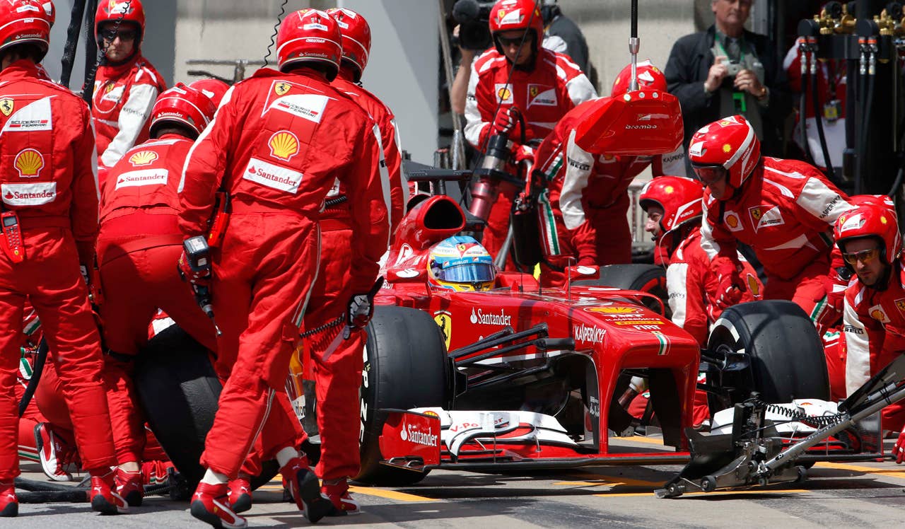 Ferrari driver Fernando Alonso of Spaiin gets a pit service during the Formula One's Canadian Grand Prix, at the Gilles Villeneuve racetrack, in Montreal, Canada, Sunday, June 9, 2013. (AP Photo/Luca Bruno)