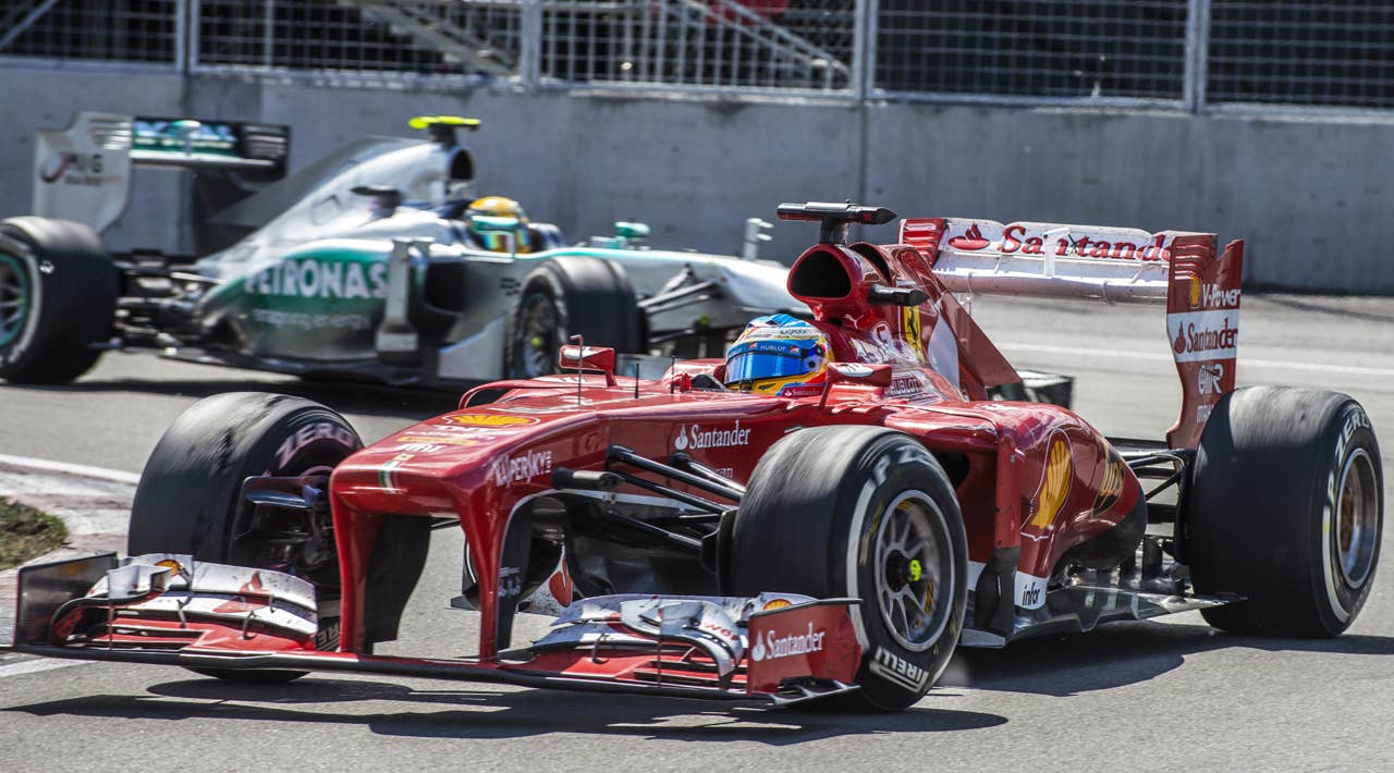 Ferrari driver Fernando Alonso of Spain leads Mercedes driver Lewis Hamilton of Britain in the hairpin corner at the Circuit Gilles Villeneuve in Montreal on June 9, 2013 during the Canadian Formula One Grand Prix.    AFP PHOTO / ROGERIO BARBOSAROGERIO BARBOSA/AFP/Getty Images