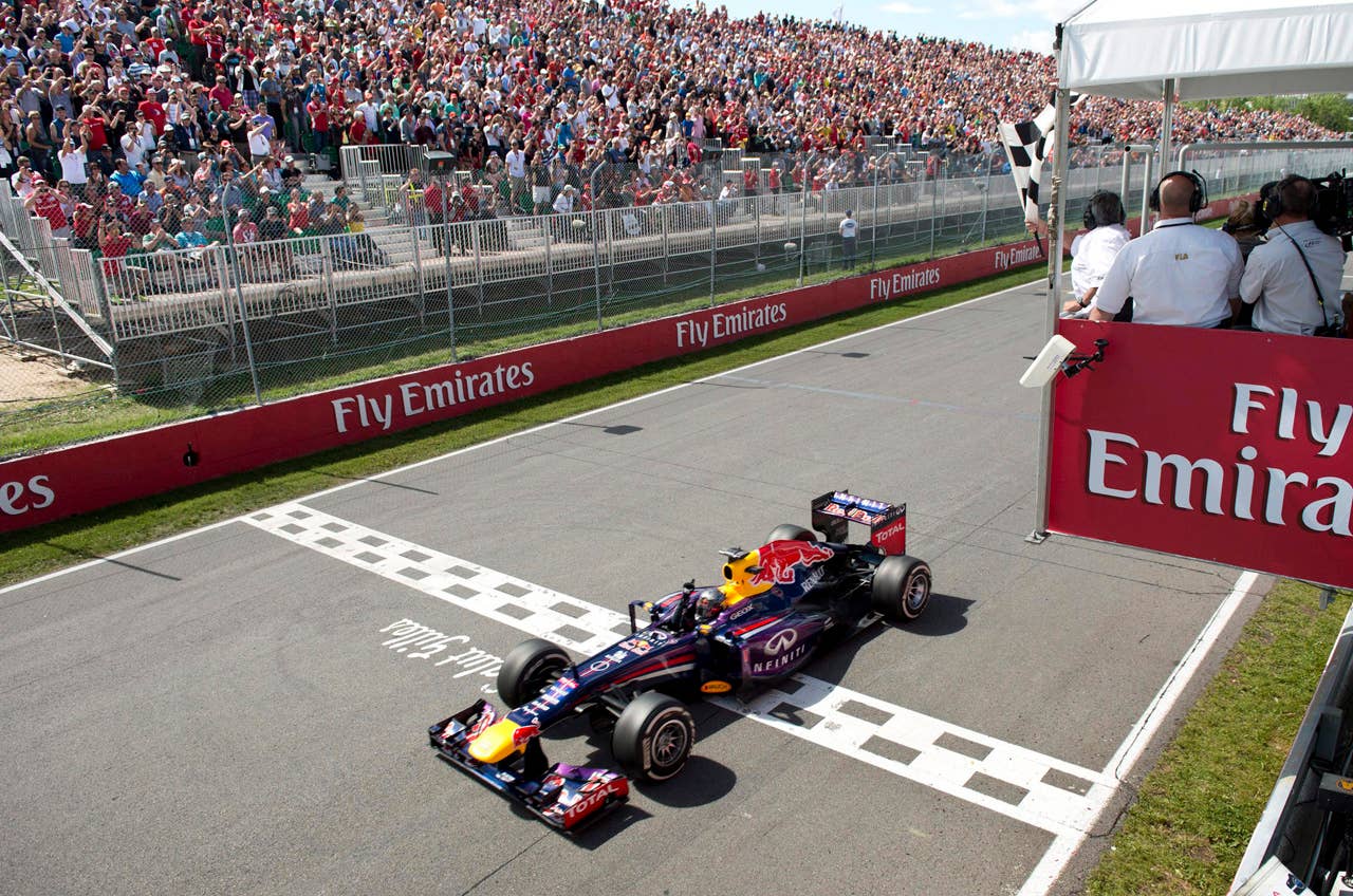 Red Bull driver Sebastian Vettel of Germany takes the checkered flag to win the Canadian Grand Prix, Sunday, June 9, 2013 in Montreal. (AP Photo/ The Canadian Press, Paul Chiasson)