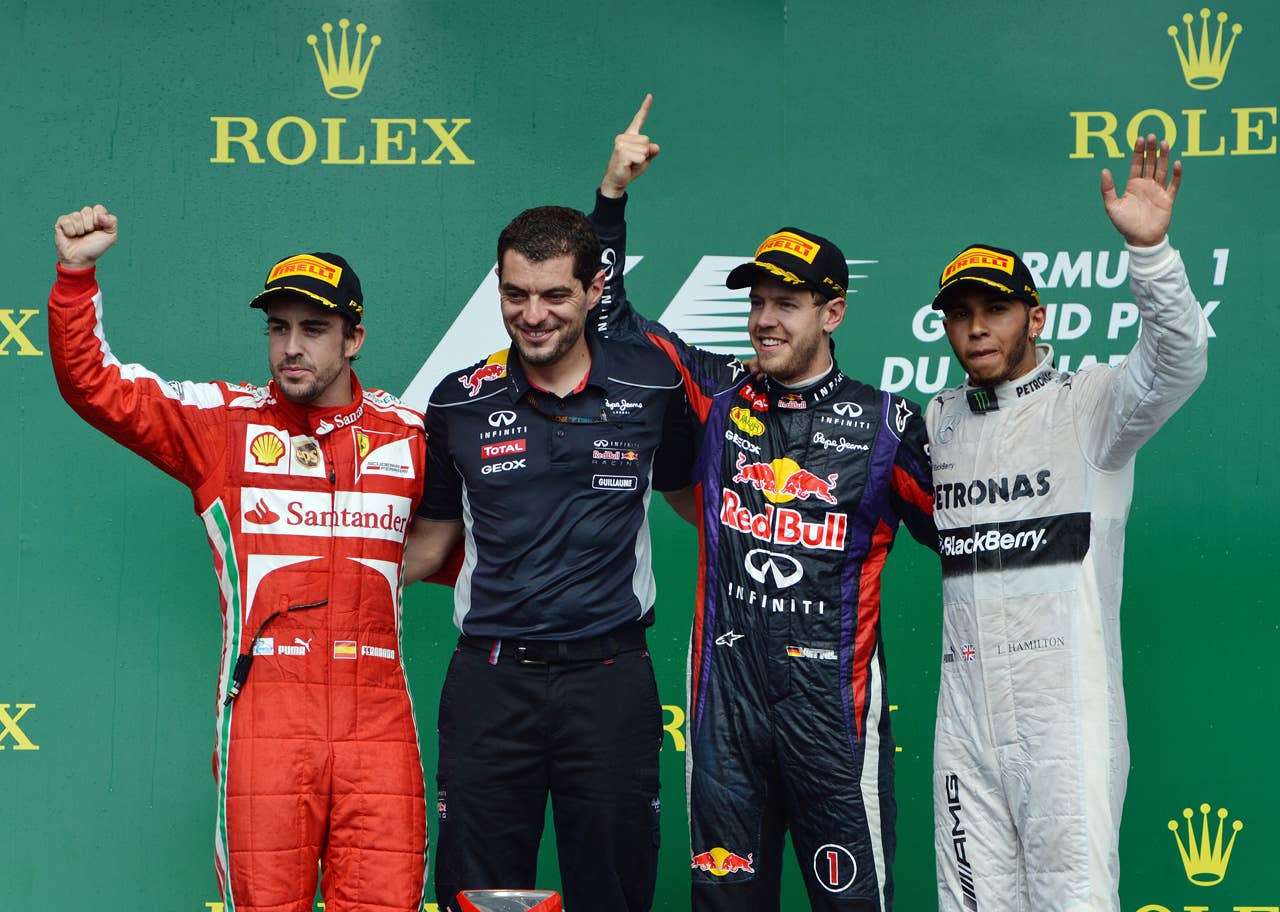 Red Bull driver Sebastian Vettel of Germany (2nd R) celebrates his win in the Canadian Formula One Grand Prix with his race engineer Guillaume Rocquelin (2nd L), second place finisher Ferrari driver Fernando Alonso of Spain (L) and third place finisher Mercedes driver Lewis Hamilton of Britain (R) at the Circuit Gilles Villeneuve in Montreal June 9, 2013.    AFP PHOTO/Stan HONDASTAN HONDA/AFP/Getty Images