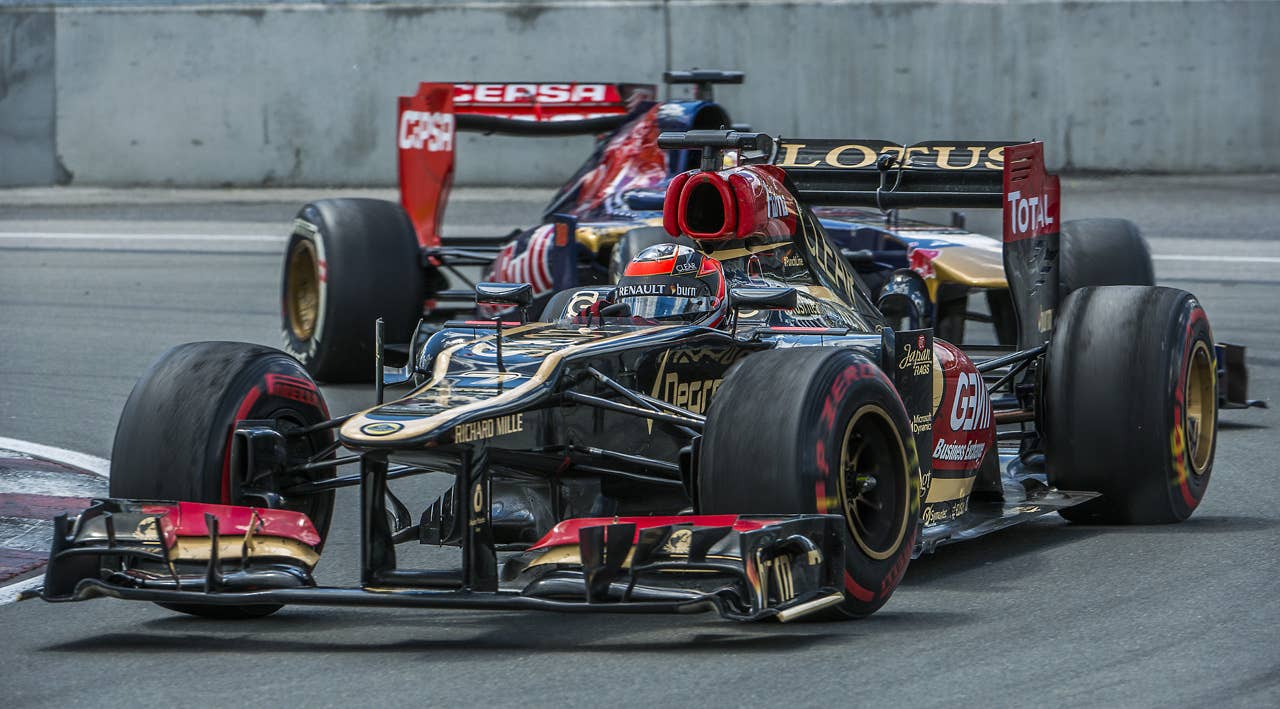 Lotus driver Kimi Raikkonen of Finland in front of Toro Rosso's Jean-Eric Vergne of France pass the hairpin corner at the Circuit Gilles Villeneuve in Montreal on June 9, 2013 during the Canadian Formula One Grand Prix.    AFP PHOTO / ROGERIO BARBOSAROGERIO BARBOSA/AFP/Getty Images