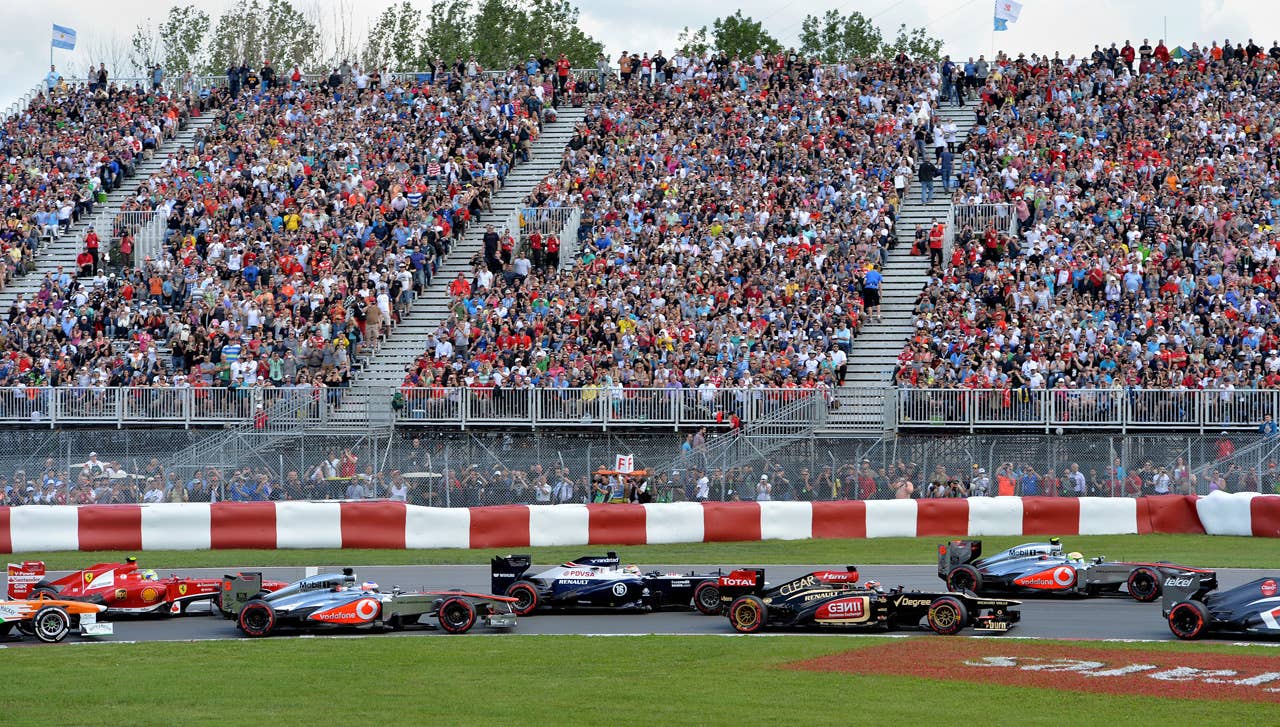 Cars enter turn two in the opening laps of the Canadian Formula One Grand Prix at the Circuit Gilles Villeneuve in Montreal on June 9, 2013.     AFP PHOTO/Stan HONDASTAN HONDA/AFP/Getty Images